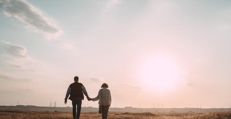 Couple holding hands in the sunset