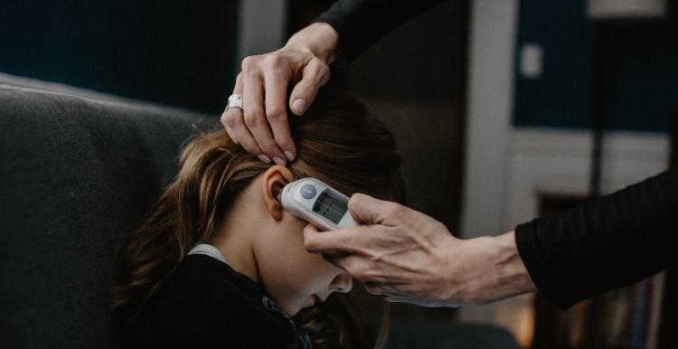 Child having temperature taken