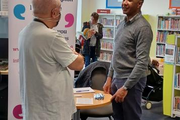 Healthwatch Barnet staff talking to member of the public New Barnet Library